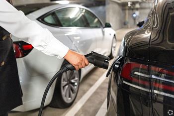 a man is refueling a car at a gas station at Le Blanc Apartment Homes, Canoga Park
